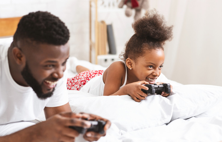 father and daughter playing video games together