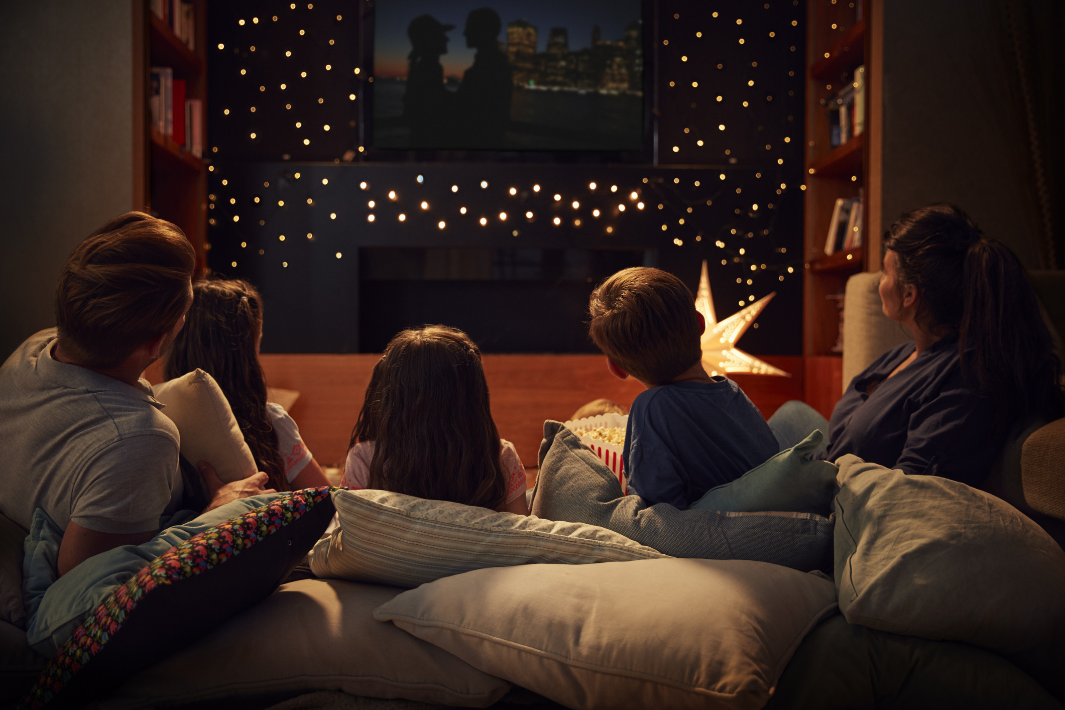 Family watching movie together in living room